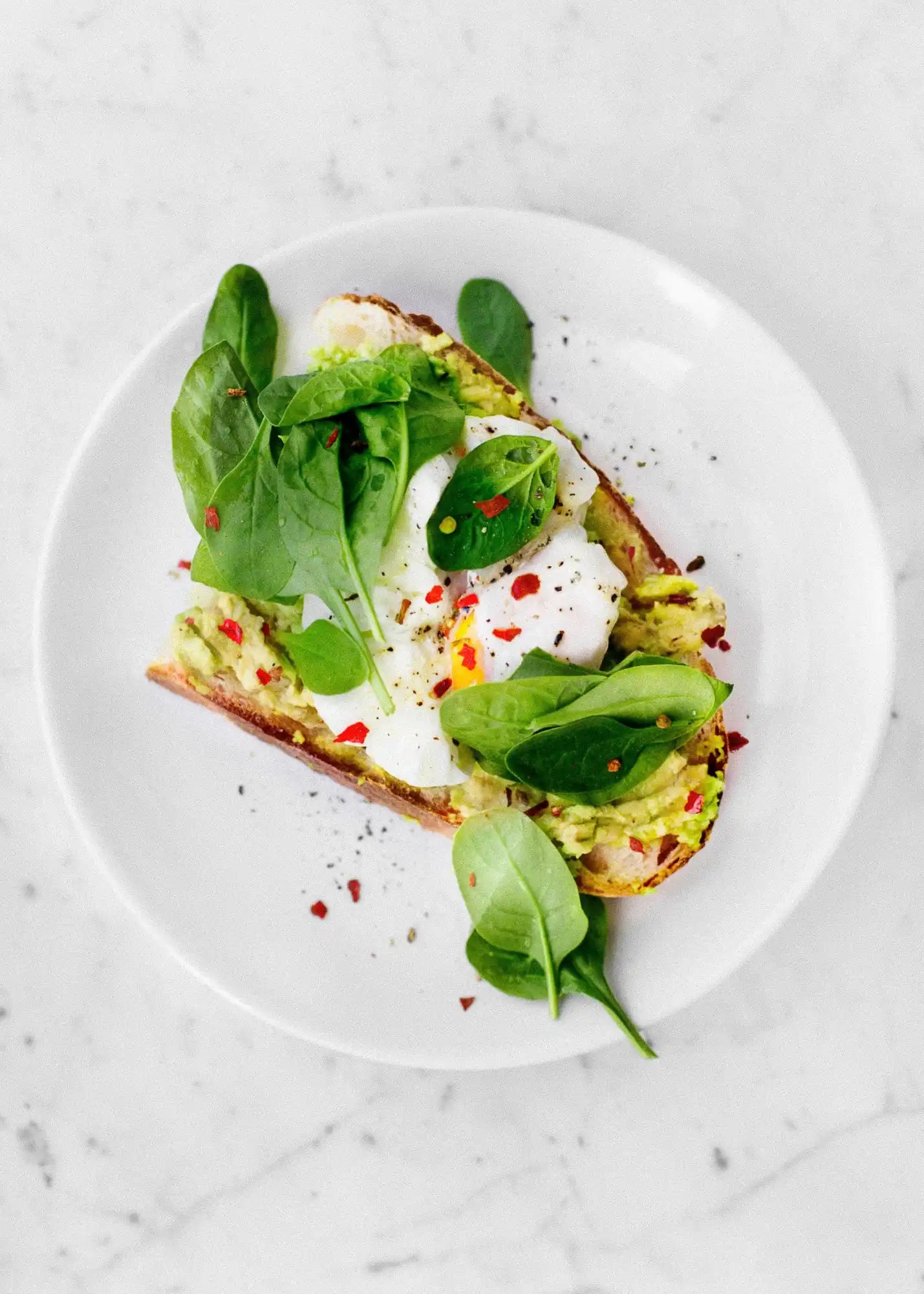 Perfectly Seasoned Poached Eggs, Avocado & Sourdough bread with freshly ground black pepper and rock salt..