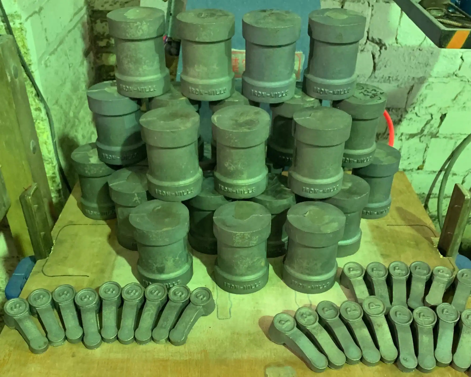 Collection of industrial pipe fittings and connectors arranged in rows.