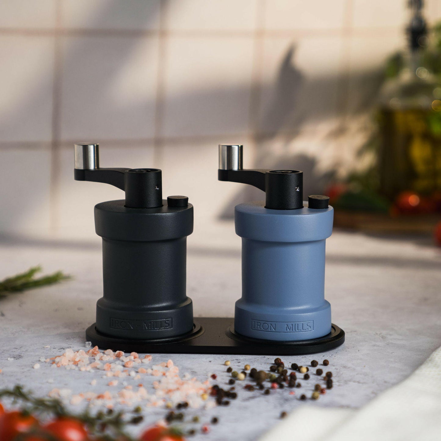 Iron-Mills anthracite grey and pigeon blue salt and pepper mills showcased on a classic rest
