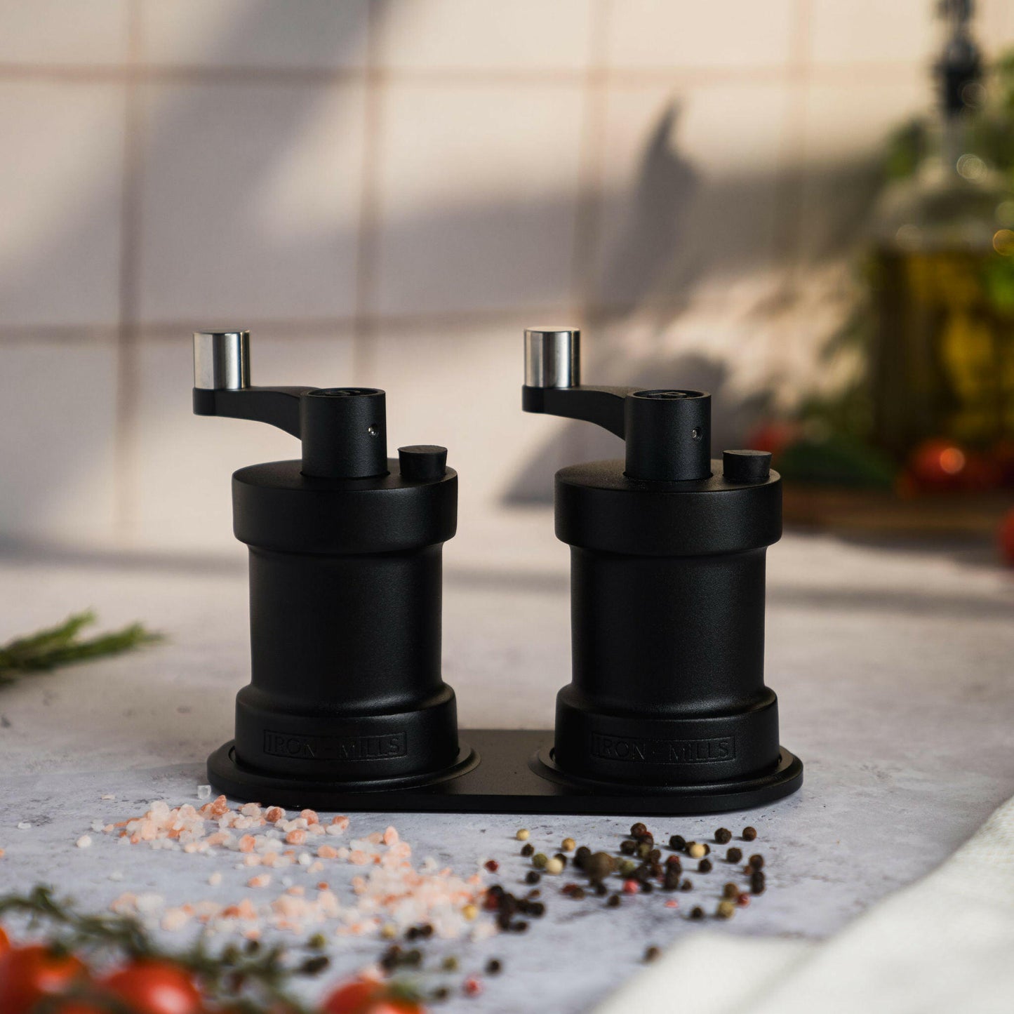 Iron-Mills onyx black salt and pepper mills displayed on a rest for showcasing their bold design