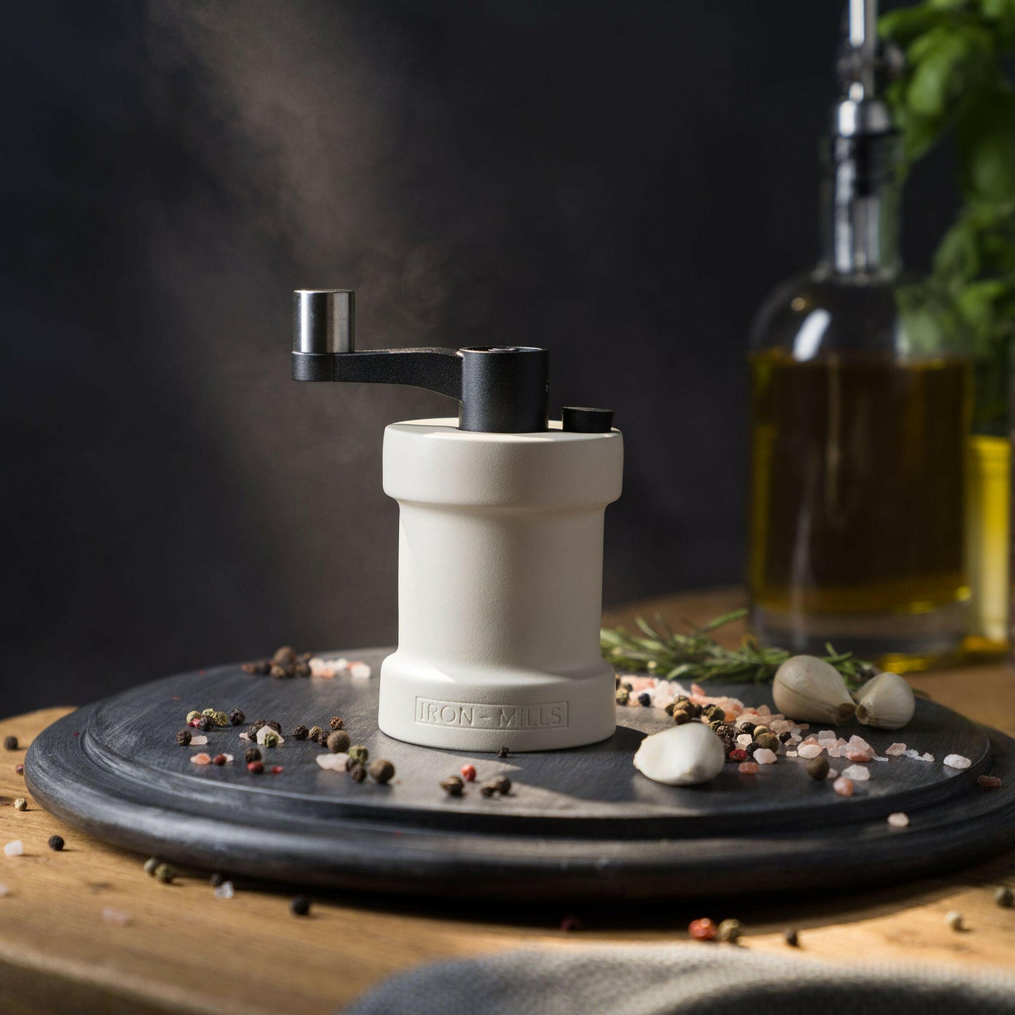 Iron-Mills oyster white salt mill on a chopping board in a classic kitchen with salt and peppercorns