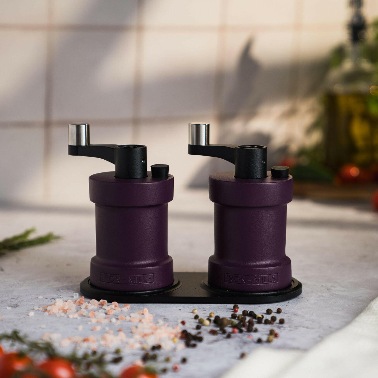 Iron-Mills purple salt and pepper mills displayed on a rest showcasing their bold and elegant colour