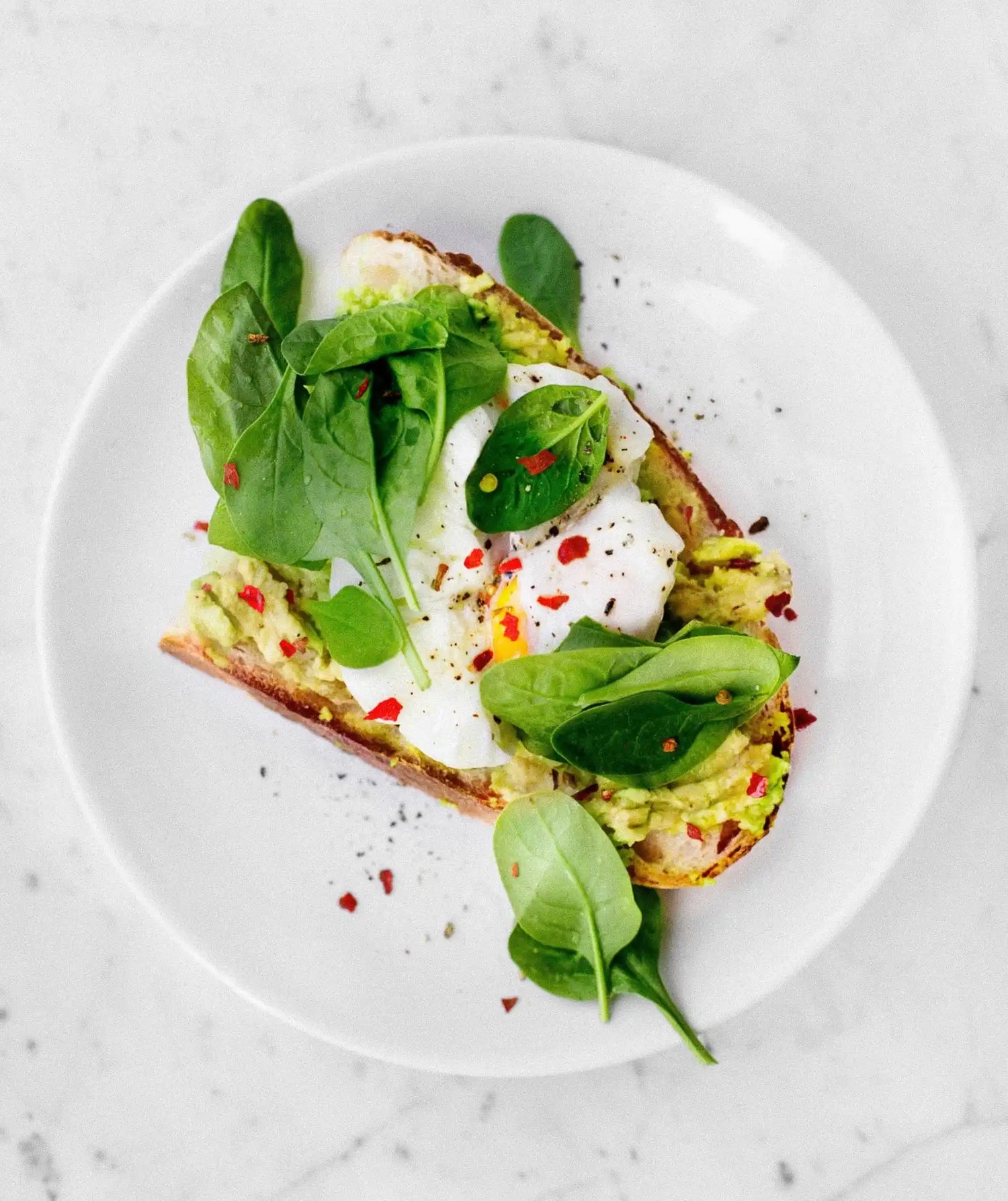 Beautifully Seasoned Poached Eggs, Smashed Avocados & Spinach on Toasted Sour Dough Bread. Seasoned with Iron-Mills Cast Iron Salt & Pepper Mills